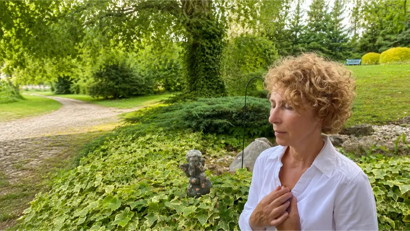 Milangela taking a quiet moment of meditation in the garden